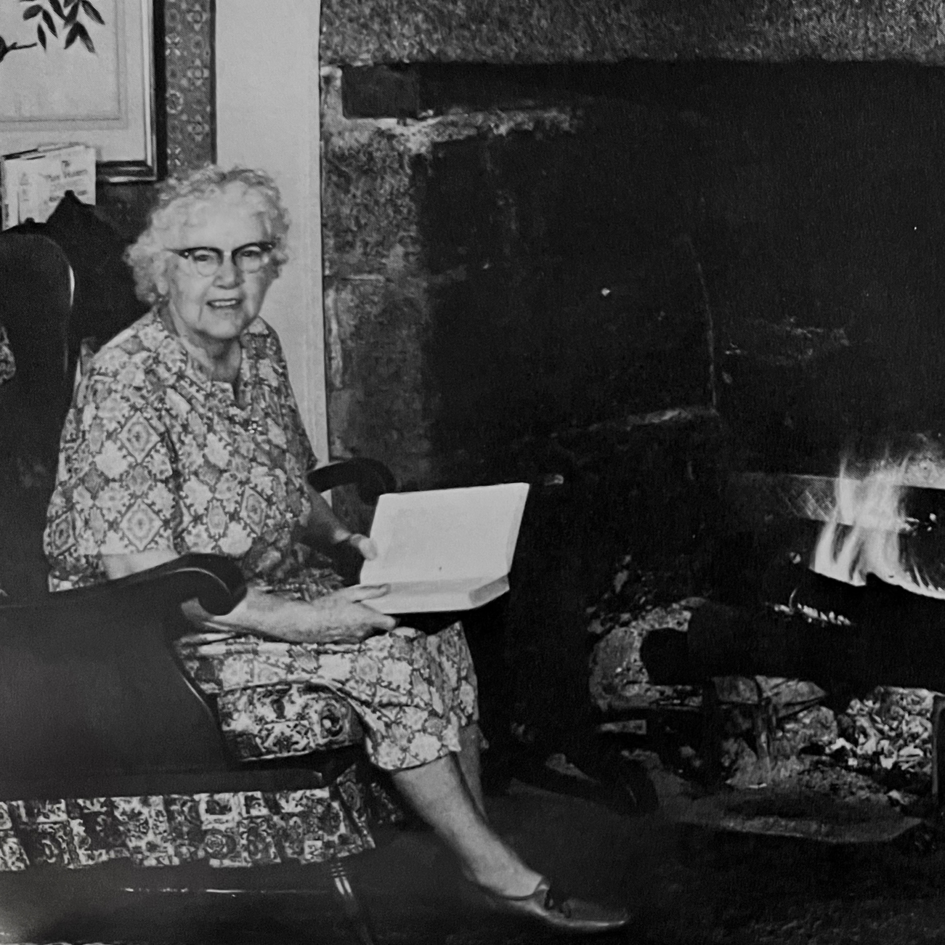 woman reading by fireplace
